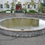 Pond made from stone, flower beds made from stone